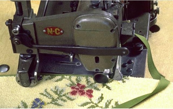 It is applied to machine made carpets to finish the sides and the ends. A cotton tape is sew from the face to the back of the carpet and is available in numerous colors.