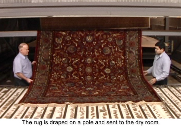 The rug is draped on a pole and sent the drying room.